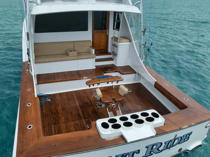 Let It Ride Yacht Photos Pics 2008 Sculley Custom Carolina boat with wooden deck, fishing chairs, and rod holders on open sea.