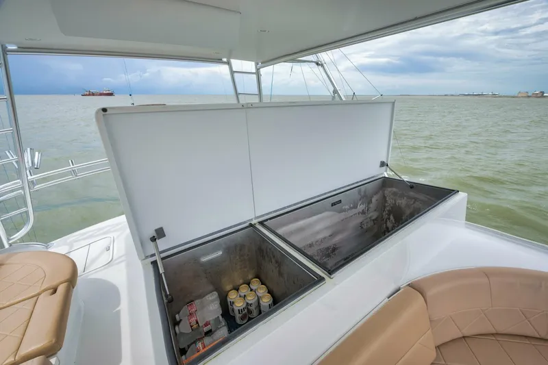 Let It Ride Yacht Photos Pics Open cooler on 2008 Sculley Custom Carolina boat deck, stocked with beverages, overlooking the sea.