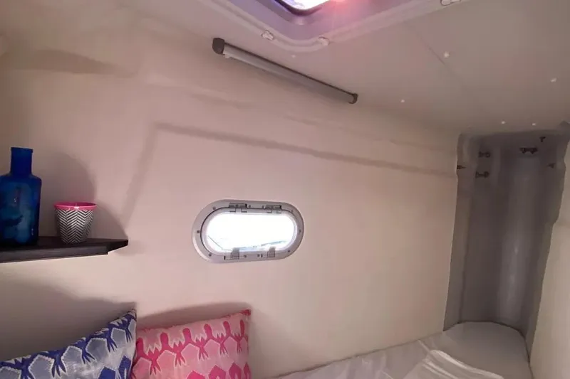 Xclip Yacht Photos Pics Cozy cabin interior of 2015 Fountaine Pajot SABA 50 with decorative pillows and porthole.