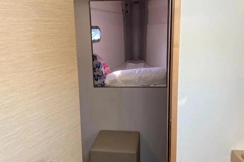 Xclip Yacht Photos Pics Interior cabin of 2015 Fountaine Pajot SABA 50 catamaran, featuring a cozy bed and window.