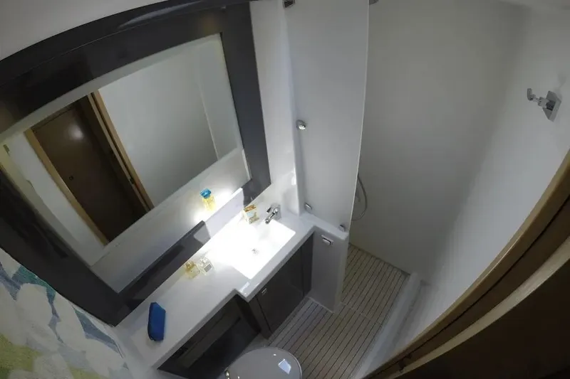 Xclip Yacht Photos Pics Bathroom interior of 2015 Fountaine Pajot SABA 50 yacht, featuring modern fixtures and mirror.