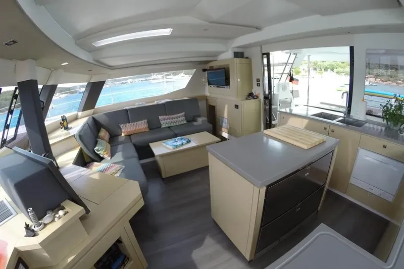 Xclip Yacht Photos Pics Luxurious interior of 2015 Fountaine Pajot SABA 50 catamaran with modern kitchen and seating area.