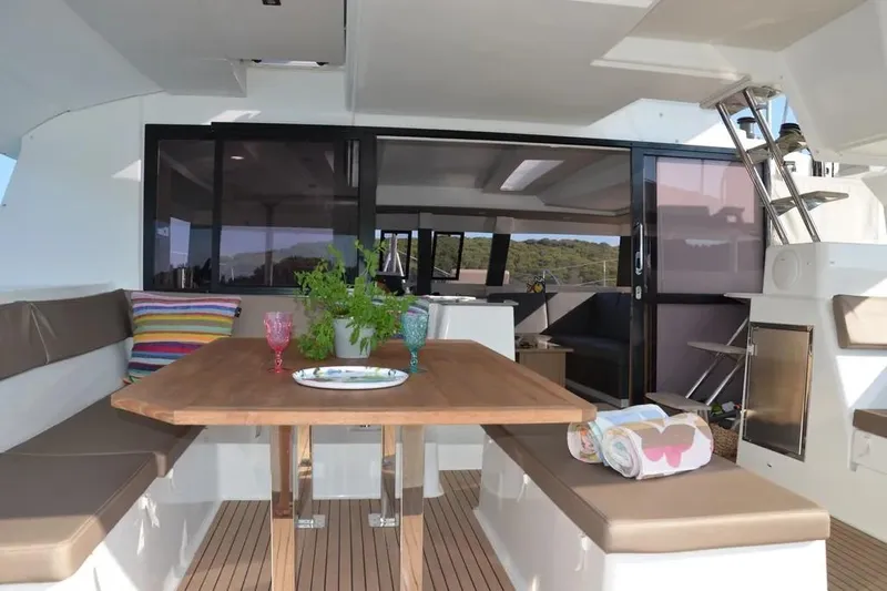 Xclip Yacht Photos Pics Luxurious 2015 Fountaine Pajot SABA 50 yacht interior with dining area and colorful decor.