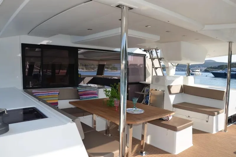 Xclip Yacht Photos Pics Luxurious 2015 Fountaine Pajot SABA 50 yacht interior with dining area and scenic view.