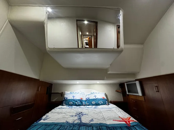 Sweet Melissa Yacht Photos Pics Cozy bedroom in 1992 Ocean Yachts 48 Convertible with nautical-themed bedding.