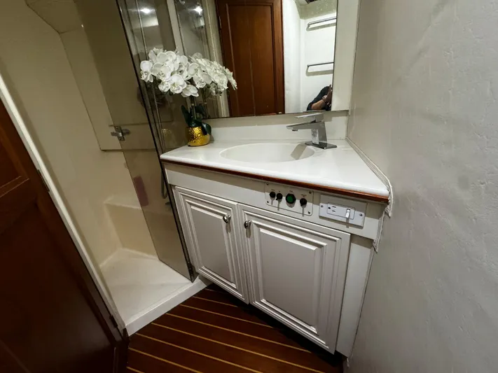 Sweet Melissa Yacht Photos Pics Luxurious bathroom in 1992 Ocean Yachts 48 Convertible with elegant vanity and floral decor.