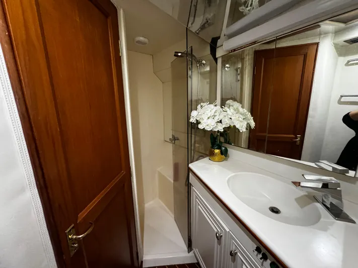 Sweet Melissa Yacht Photos Pics Luxurious bathroom in 1992 Ocean Yachts 48 Convertible, featuring elegant sink and shower.