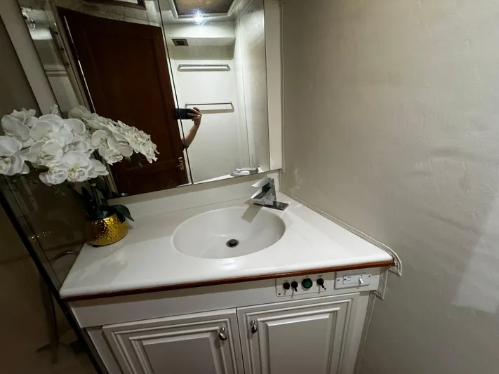 Sweet Melissa Yacht Photos Pics Bathroom vanity on 1992 Ocean Yachts 48 Convertible with flowers and mirror.