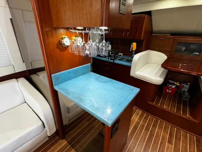 Sweet Melissa Yacht Photos Pics Luxurious 1992 Ocean Yachts 48 Convertible interior with blue countertop and wooden accents.