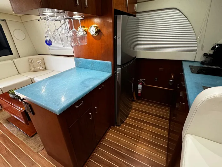 Sweet Melissa Yacht Photos Pics Luxurious interior of 1992 Ocean Yachts 48 Convertible with modern kitchen and seating area.