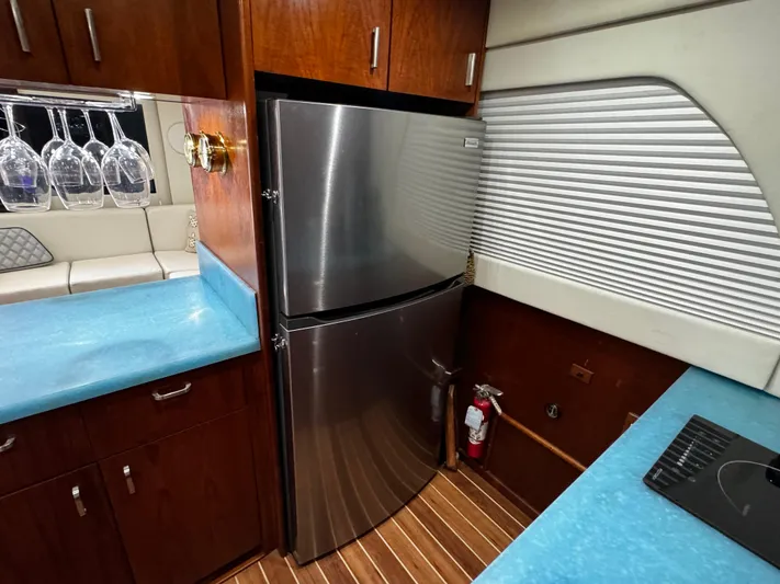 Sweet Melissa Yacht Photos Pics Luxurious 1992 Ocean Yachts 48 Convertible kitchen with stainless steel fridge and blue countertops.
