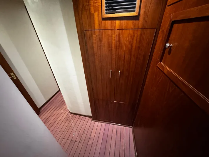 Sweet Melissa Yacht Photos Pics Interior hallway of 1992 Ocean Yachts 48 Convertible with wooden cabinetry and flooring.