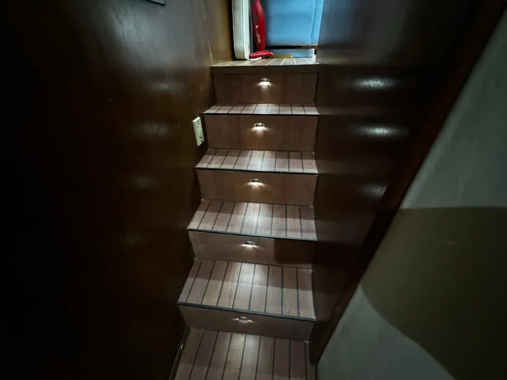 Sweet Melissa Yacht Photos Pics Wooden staircase with ambient lighting on a 1992 Ocean Yachts 48 Convertible.
