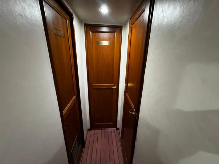 Sweet Melissa Yacht Photos Pics Narrow hallway with wooden doors inside a 1992 Ocean Yachts 48 Convertible.