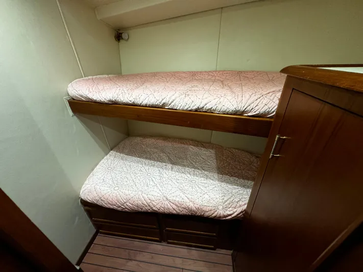 Sweet Melissa Yacht Photos Pics Bunk beds in 1992 Ocean Yachts 48 Convertible cabin with wooden flooring.