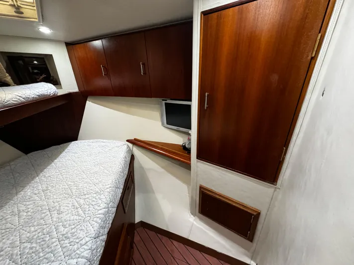Sweet Melissa Yacht Photos Pics Interior cabin of 1992 Ocean Yachts 48 Convertible with wood cabinets and cozy bedding.