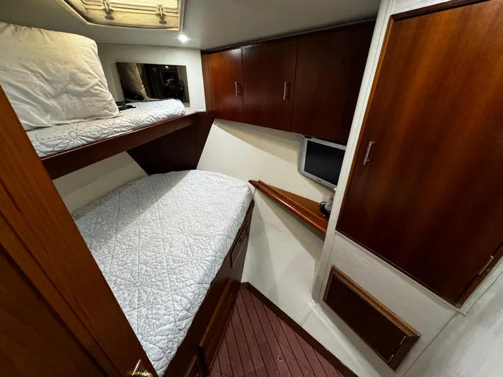 Sweet Melissa Yacht Photos Pics Cozy cabin interior of 1992 Ocean Yachts 48 Convertible with wooden finishes and bunk beds.