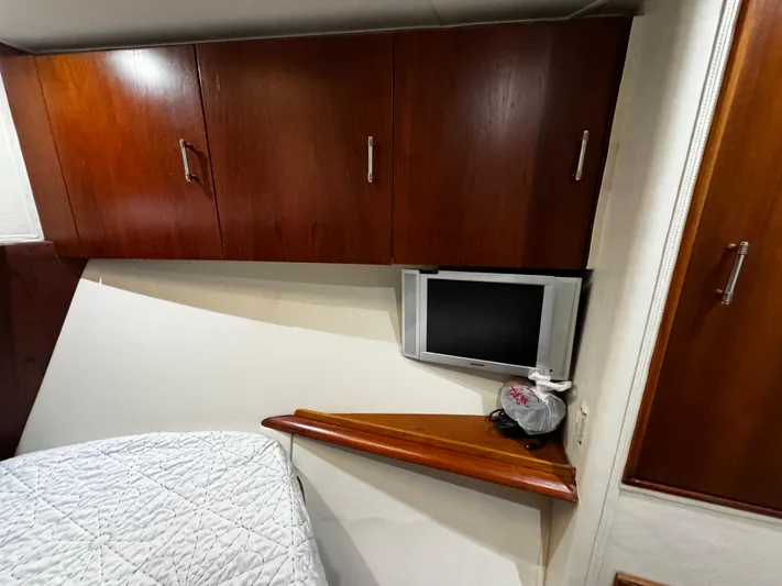 Sweet Melissa Yacht Photos Pics Interior of 1992 Ocean Yachts 48 Convertible with wood cabinets and small TV.