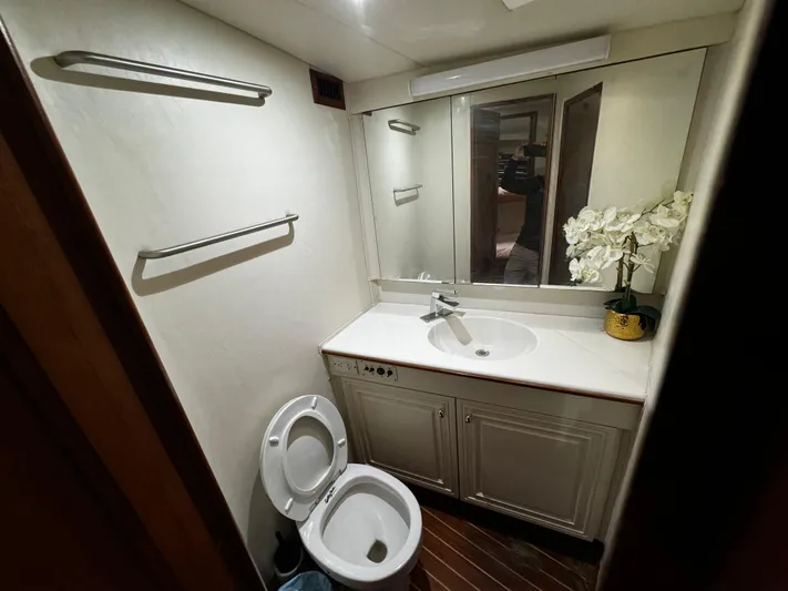 Sweet Melissa Yacht Photos Pics Bathroom interior of 1992 Ocean Yachts 48 Convertible, featuring sink, toilet, and mirror.