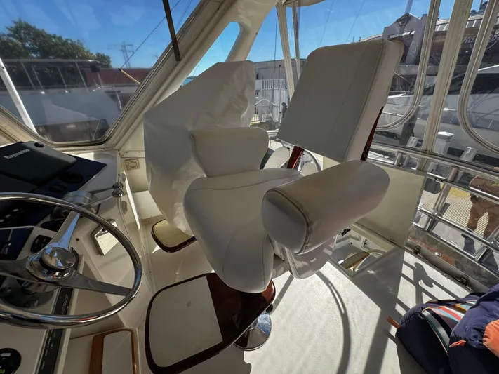 Sweet Melissa Yacht Photos Pics Interior helm of 1992 Ocean Yachts 48 Convertible with white captain's chairs.