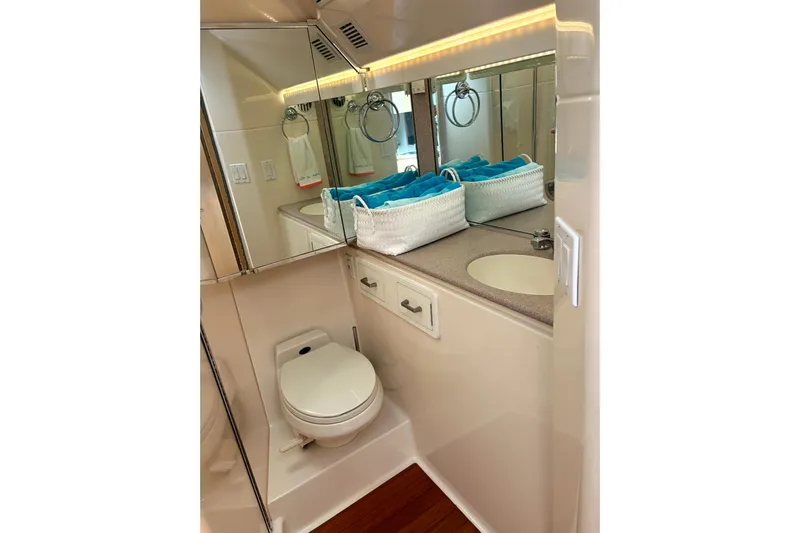  Yacht Photos Pics Bathroom interior of 1993 Tiara Yachts 43 Open, featuring toilet and sink with mirror.