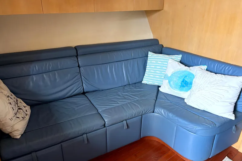  Yacht Photos Pics Blue leather seating area with decorative pillows on a 1993 Tiara Yachts 43 Open.