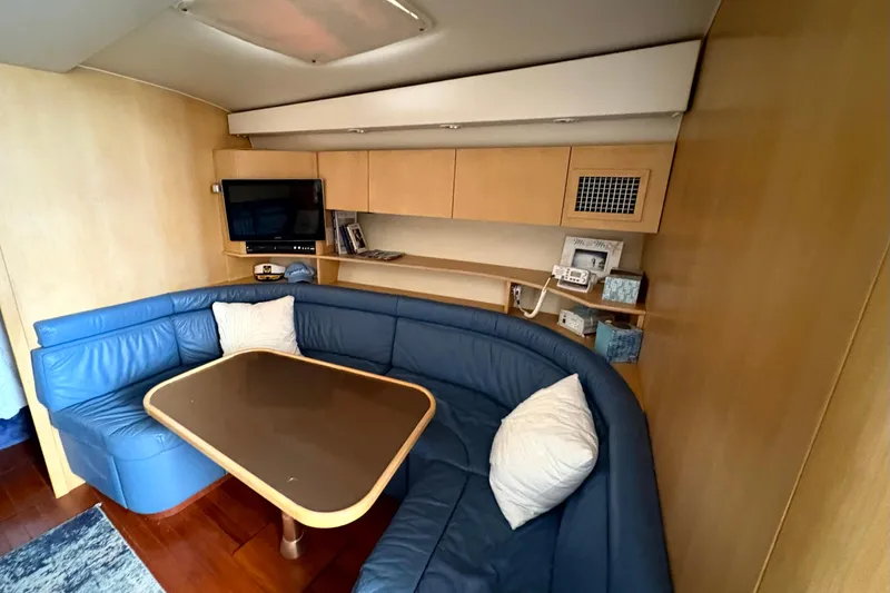  Yacht Photos Pics Interior of 1993 Tiara Yachts 43 Open with blue seating and wooden table.