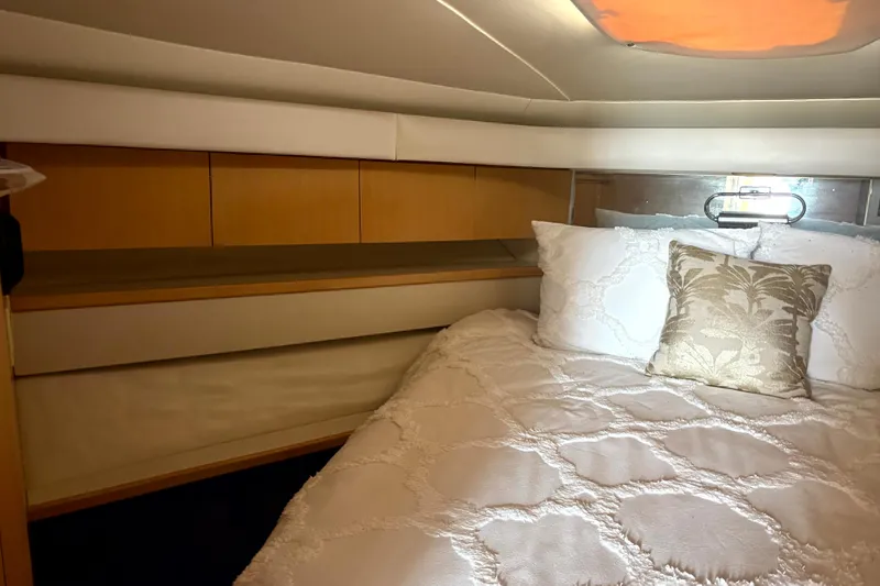  Yacht Photos Pics Cozy cabin interior of 1993 Tiara Yachts 43 Open with elegant bedding and wood accents.
