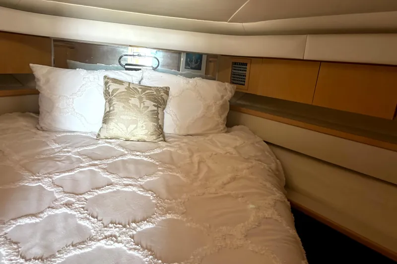  Yacht Photos Pics Luxurious cabin interior of 1993 Tiara Yachts 43 Open with elegant bedding.
