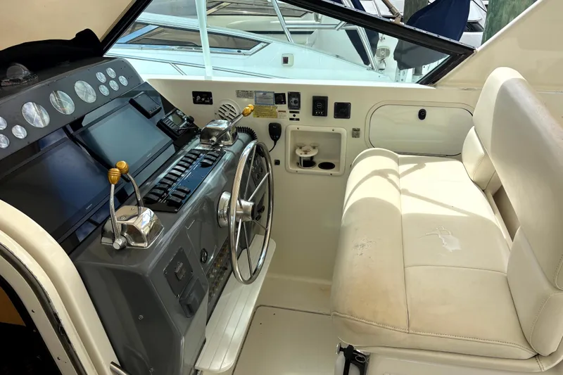  Yacht Photos Pics 1993 Tiara Yachts 43 Open helm with steering wheel and control panel.