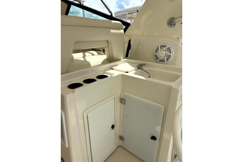  Yacht Photos Pics 1993 Tiara Yachts 43 Open interior with sink, storage, and cup holders.