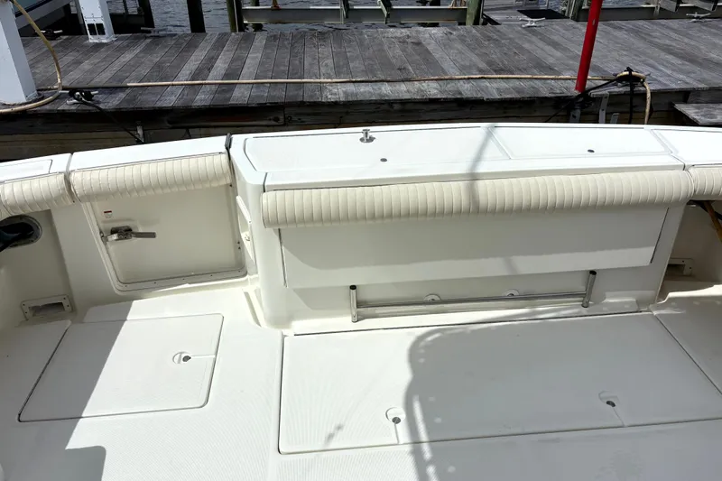  Yacht Photos Pics 1993 Tiara Yachts 43 Open deck with seating and storage, docked at marina.