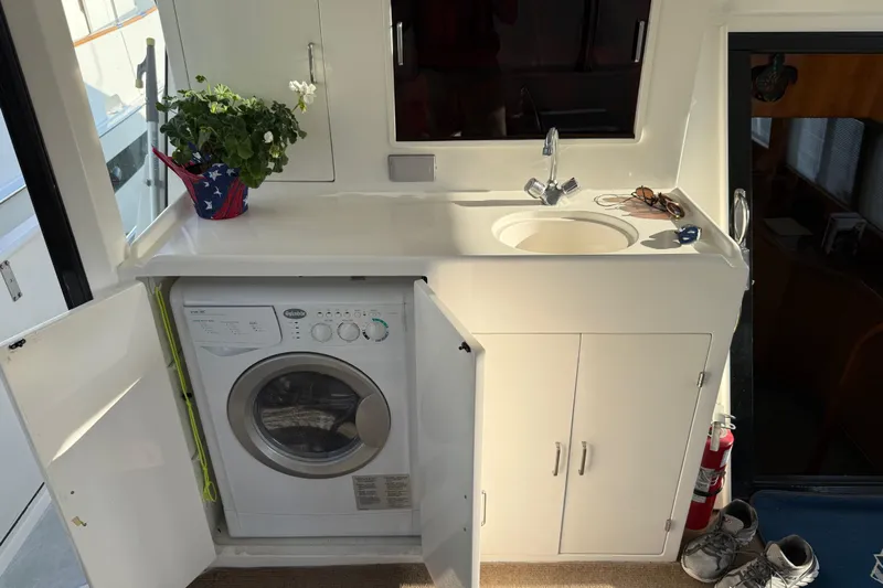  Yacht Photos Pics 2000 Novatec Cockpit Motor Yacht interior with sink, washing machine, and potted plant.