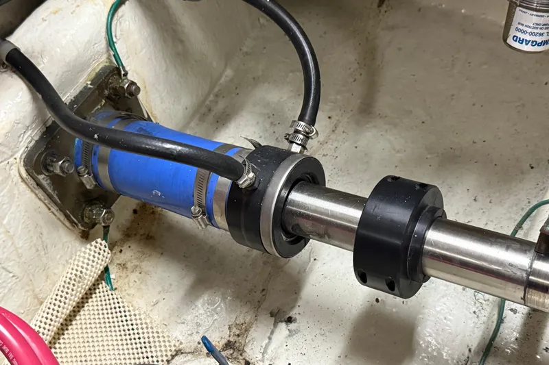  Yacht Photos Pics Novatec Cockpit Motor Yacht 2000 engine shaft with blue hose and metal clamps.