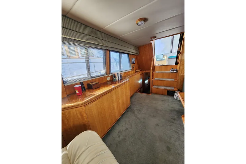  Yacht Photos Pics Interior of 2000 Novatec Cockpit Motor Yacht with wooden cabinetry and carpeted flooring.