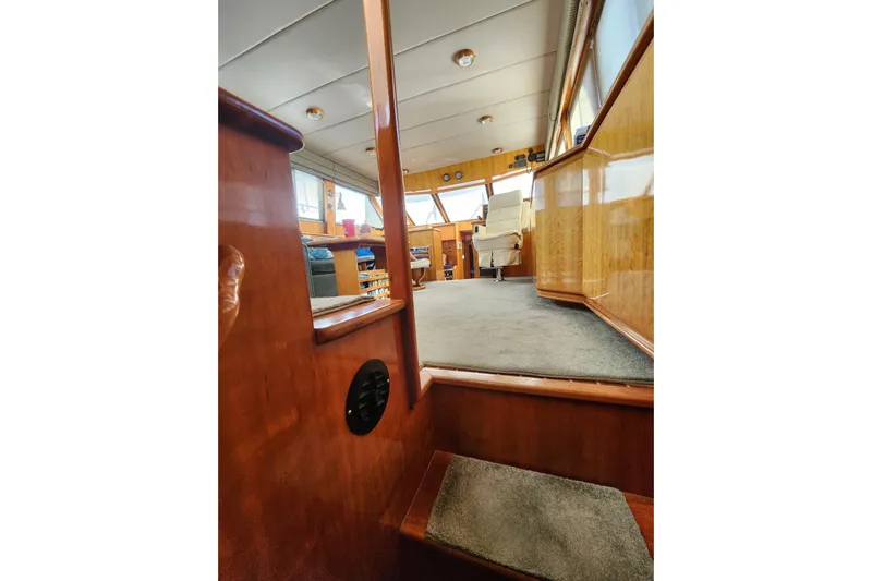  Yacht Photos Pics Interior view of 2000 Novatec Cockpit Motor Yacht with wooden finishes and carpeted flooring.