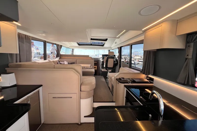  Yacht Photos Pics Luxurious interior of 2025 Nimbus 495 Flybridge yacht with modern furnishings and panoramic windows.
