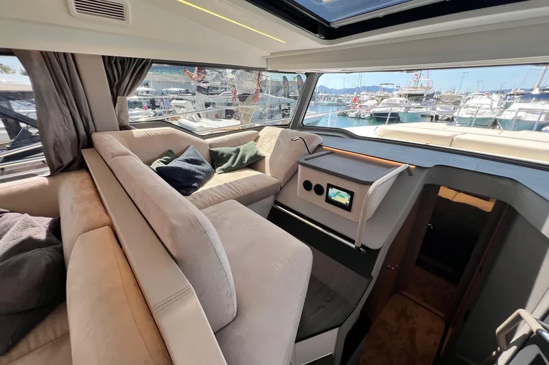  Yacht Photos Pics Luxurious interior of 2025 Nimbus 495 Flybridge yacht with plush seating and marina view.