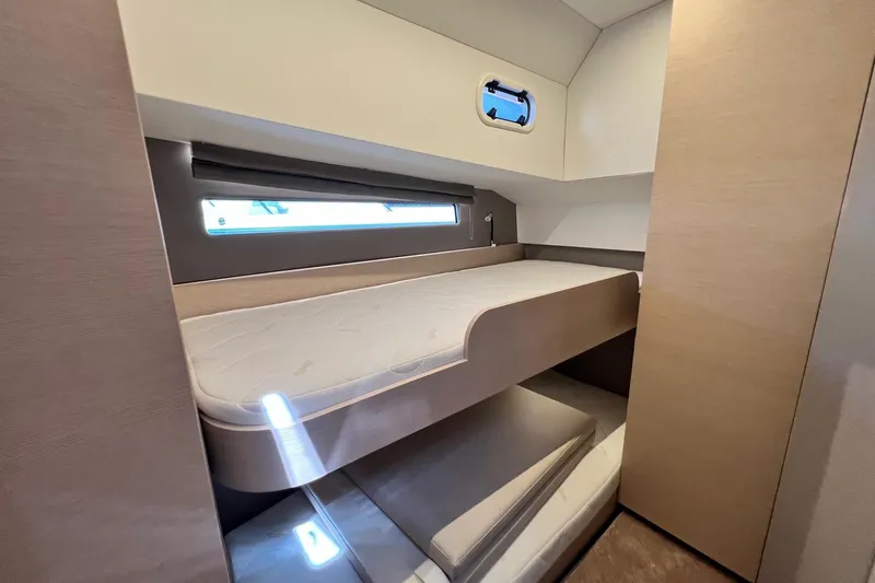  Yacht Photos Pics 2025 Nimbus 495 Flybridge cabin with bunk beds and modern interior design.
