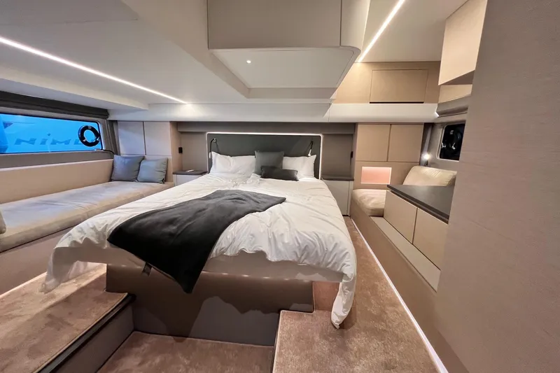  Yacht Photos Pics Luxurious bedroom interior of 2025 Nimbus 495 Flybridge yacht, featuring modern design and cozy ambiance.