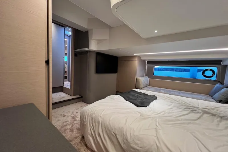  Yacht Photos Pics Luxurious interior of 2025 Nimbus 495 Flybridge yacht, featuring a cozy bedroom with modern amenities.