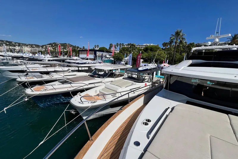  Yacht Photos Pics Luxury yachts, including Nimbus 495 Flybridge 2025, docked at a marina under clear blue skies.