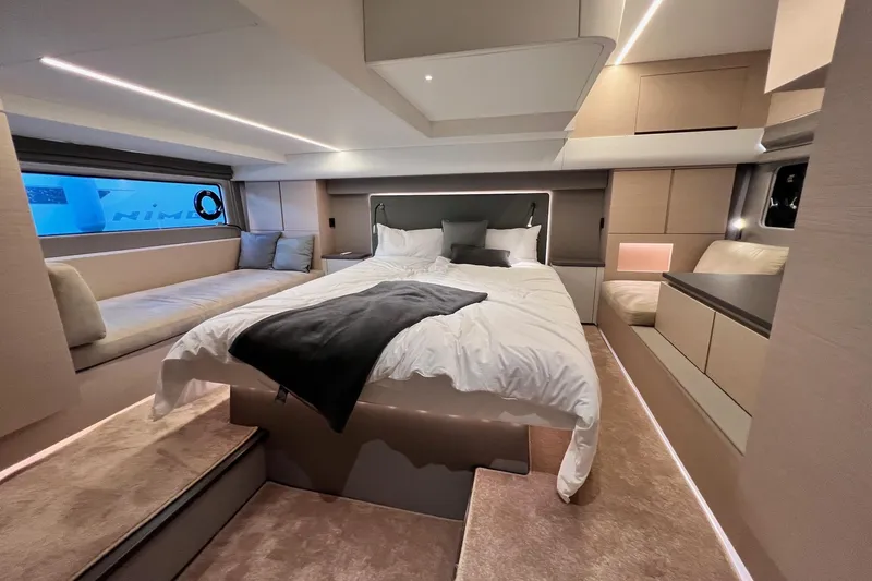  Yacht Photos Pics Luxurious bedroom interior of 2025 Nimbus 495 Flybridge yacht with modern design and cozy bedding.