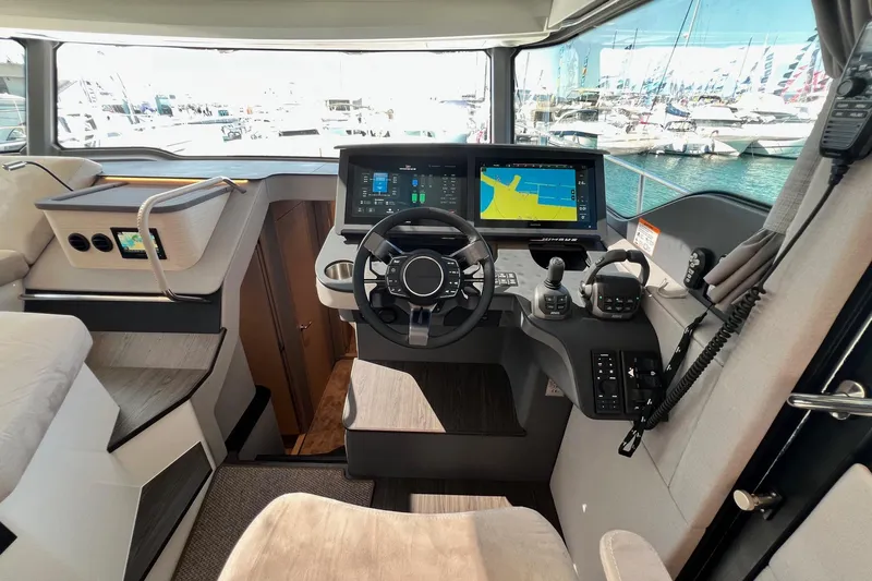  Yacht Photos Pics Helm of 2025 Nimbus 495 Flybridge yacht with advanced navigation systems and controls.