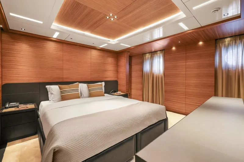 Magna Grecia Yacht Photos Pics Luxurious yacht bedroom with wood paneling, modern lighting, and elegant decor, 1986 Elsflether Werft.