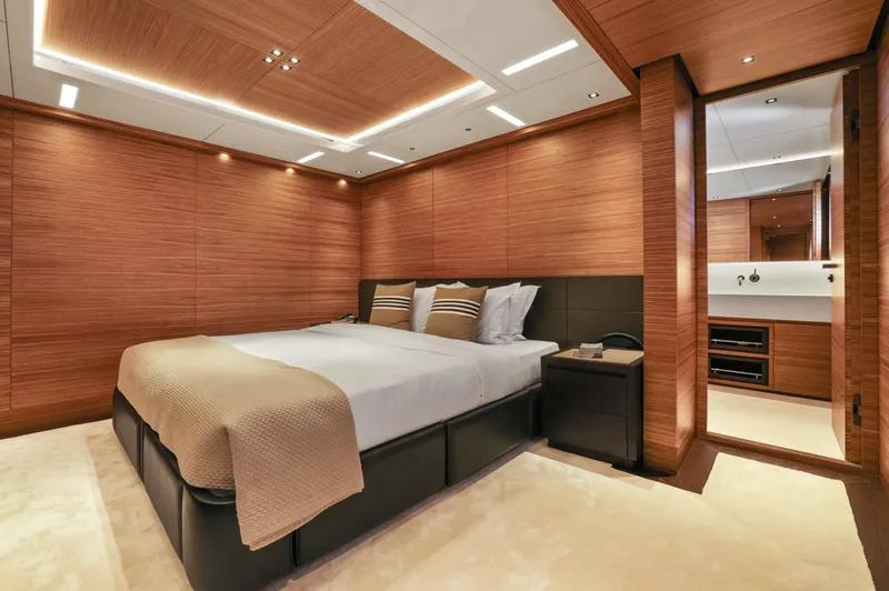 Magna Grecia Yacht Photos Pics Luxurious yacht bedroom with wood paneling, modern design, and elegant lighting, Elsflether Werft 1986.