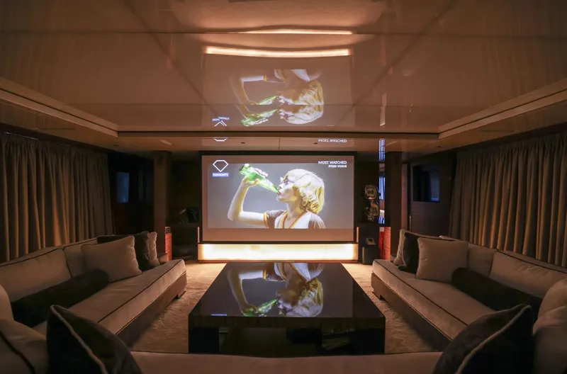 Magna Grecia Yacht Photos Pics Luxurious yacht interior with home theater, plush seating, and modern decor, Elsflether Werft 1986.