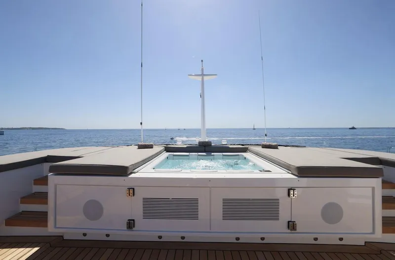 Magna Grecia Yacht Photos Pics Luxury yacht deck with jacuzzi, ocean view, clear sky, Elsflether Werft 1986 model.