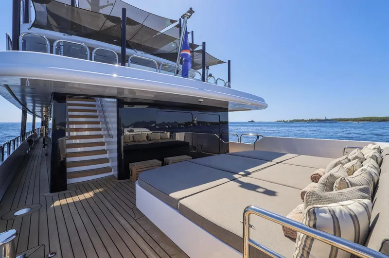 Magna Grecia Yacht Photos Pics Luxurious yacht deck with sun loungers, cushions, and ocean view, Custom Elsflether Werft 1986.