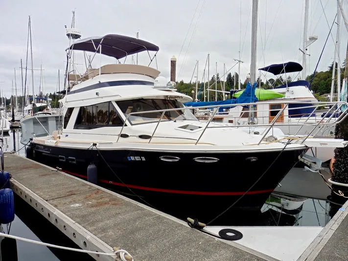  Yacht Photos Pics 2015 Cutwater 30CB yacht docked at marina, featuring sleek design and spacious cabin.